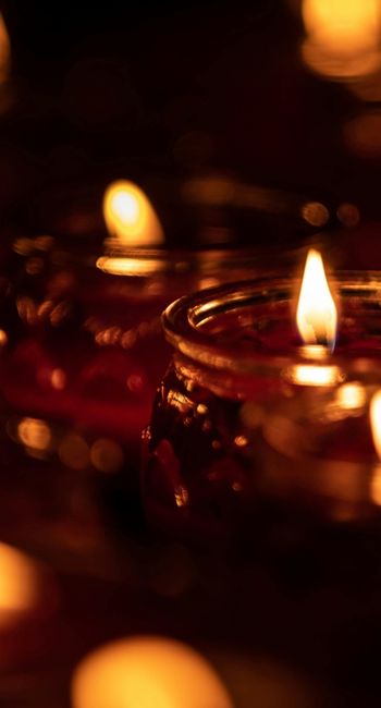 Candles grouped in the darkness to bring in the light.