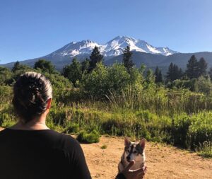 Amy prepares to teach Reiki class in Mt. Shasta, offering Reiki to the mountain, Rila sits and watches.