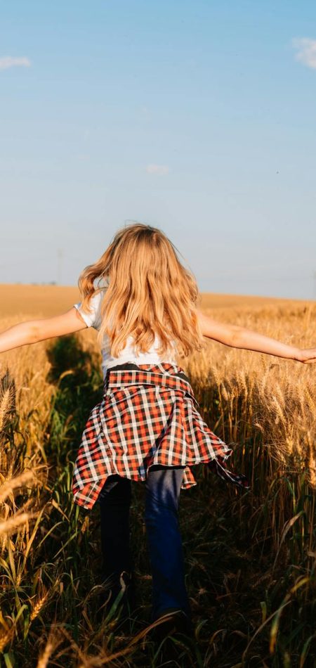 pexels-photo-27903953 a girl walking through a wheat field